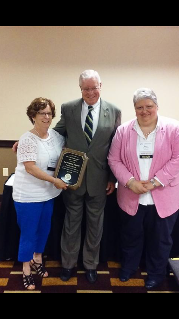Missouri State Rep. Bill Lant (center), Chair, Joint Committee on Child Abuse and Neglect, and Bev Newman (right), President, Missouri Juvenile Justice Association, present the award to Catherine Horejes (left), Chief Deputy Juvenile Officer - Special Services Department, 22nd Judicial Circuit.